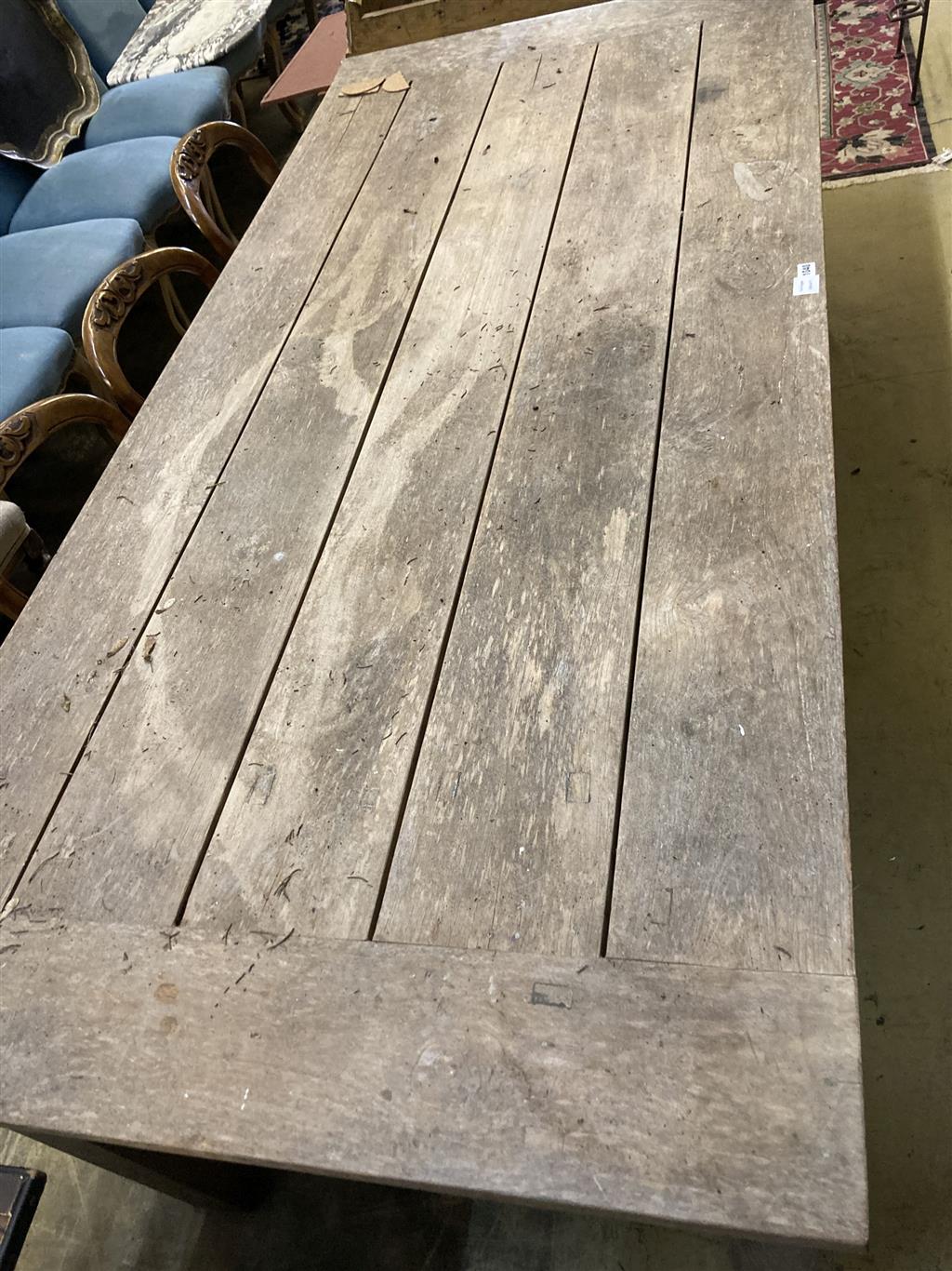 A large rectangular weathered teak garden table, width 220cm, depth 99cm, height 79cm